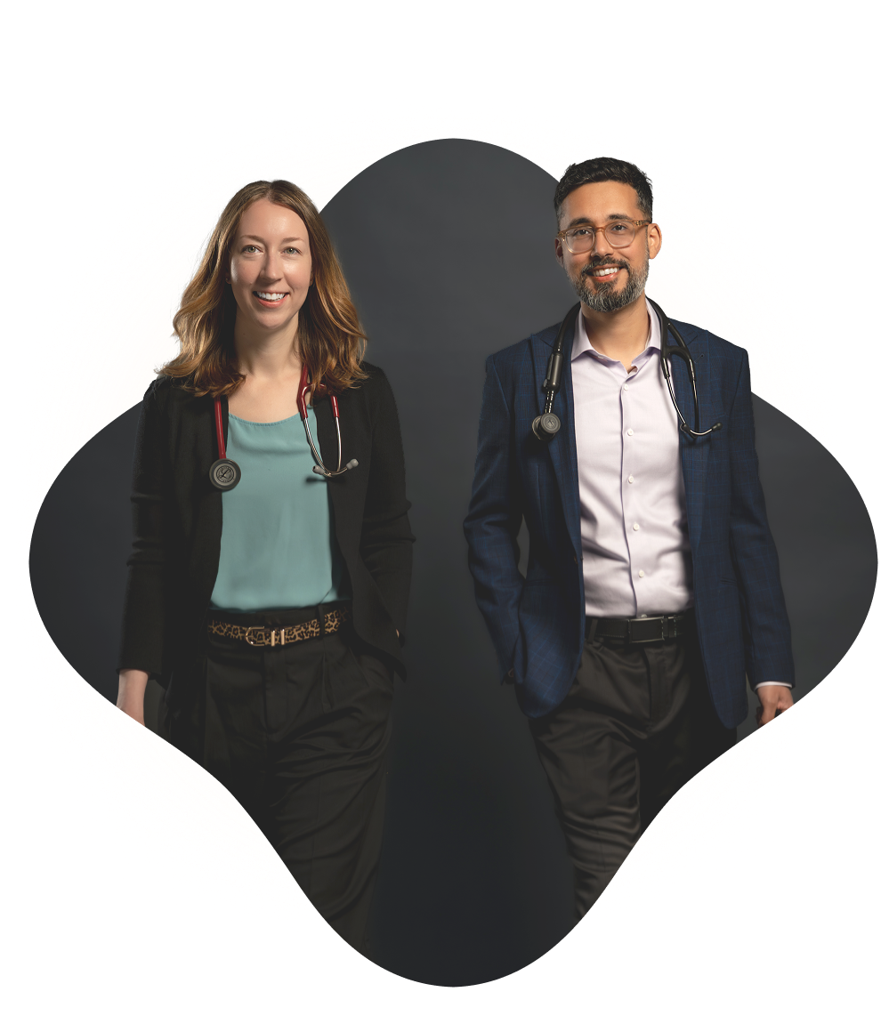Variant12 Two smiling healthcare professionals, a woman and a man, both wearing stethoscopes around their necks, stand side by side against a dark background, representing a dedicated concierge medicine team.